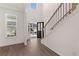 Bright foyer with hardwood floors, staircase, and view to the outside at 1858 Lacebark Elm Way, Lawrenceville, GA 30045