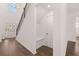 Foyer featuring hardwood floors, staircase, built-in bench and coat hooks at 1858 Lacebark Elm Way, Lawrenceville, GA 30045