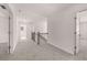 Upstairs hallway with a railing, doors, and carpeted floor at 1858 Lacebark Elm Way, Lawrenceville, GA 30045