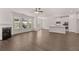 Spacious living area with hardwood floors, fireplace and kitchen featuring modern white cabinets and appliances at 1858 Lacebark Elm Way, Lawrenceville, GA 30045