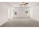 Spacious main bedroom features two windows, a ceiling fan, and tray ceiling at 1858 Lacebark Elm Way, Lawrenceville, GA 30045