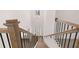Modern staircase with wood and iron railing leads to a light-filled foyer and entrance at 1858 Lacebark Elm Way, Lawrenceville, GA 30045