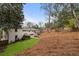 Expansive backyard with stone steps, lawn, and mature trees offers tranquility and space for outdoor enjoyment at 348 Lakemoore Ne Dr, Atlanta, GA 30342