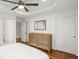 Bedroom with tray ceiling, wood floors, and a dresser at 348 Lakemoore Ne Dr, Atlanta, GA 30342