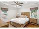 Cozy bedroom with tray ceiling, wood floors, and natural light from two windows at 348 Lakemoore Ne Dr, Atlanta, GA 30342