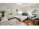 Comfortable bedroom with hardwood floors, two windows, and a cozy rug at 348 Lakemoore Ne Dr, Atlanta, GA 30342