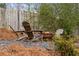 Wood Adirondack chairs surround fire pit for relaxing outdoor experience in private backyard at 348 Lakemoore Ne Dr, Atlanta, GA 30342