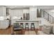 Bright kitchen boasts white cabinets, stainless steel appliances, and a center island with bar stool seating at 348 Lakemoore Ne Dr, Atlanta, GA 30342
