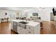 Open floor plan kitchen with eat-in island, stainless steel appliances, and wood floors at 348 Lakemoore Ne Dr, Atlanta, GA 30342
