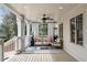 Inviting covered porch featuring comfortable seating, curtains, and a ceiling fan at 348 Lakemoore Ne Dr, Atlanta, GA 30342