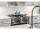 Close up of a stainless steel range oven with a blue teapot at 348 Lakemoore Ne Dr, Atlanta, GA 30342