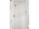 A pristine white tiled shower stall with a modern shower head and built-in niche for toiletries at 348 Lakemoore Ne Dr, Atlanta, GA 30342
