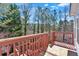 A wooden back deck offers an outdoor space with views of mature trees at 2452 Lakebrooke Dr, Marietta, GA 30066