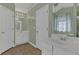 Bathroom with double sinks, large mirror, linen closet, and tile floor at 2452 Lakebrooke Dr, Marietta, GA 30066