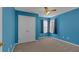 Well-lit bedroom features blue walls, a ceiling fan, and carpet flooring at 2452 Lakebrooke Dr, Marietta, GA 30066