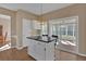 Eat-in kitchen with island seating and natural light, leading to a bright sunroom at 2452 Lakebrooke Dr, Marietta, GA 30066