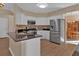 Spacious kitchen with stainless steel refrigerator and access to dining area at 2452 Lakebrooke Dr, Marietta, GA 30066