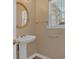Elegant powder room features a pedestal sink, gold mirror, and classic fixtures at 2452 Lakebrooke Dr, Marietta, GA 30066