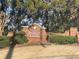 The Barrett Creek community sign sits at the entrance framed with a brick wall and greenery at 2452 Lakebrooke Dr, Marietta, GA 30066