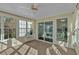 Bright sunroom with abundant windows and a ceiling fan, perfect for relaxation and enjoying natural light at 2452 Lakebrooke Dr, Marietta, GA 30066