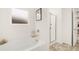 Modern bathroom featuring a white soaking tub, chrome fixtures, and a separate glass enclosed shower at 5417 Flat Rock Pt, Stonecrest, GA 30038