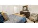 A bedroom with a well-decorated dresser, chair, and comfortable bed at 5417 Flat Rock Pt, Stonecrest, GA 30038