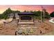 The Enclave at Flat Rock Hills entrance is beautifully landscaped with stone details and colorful flowers at 5417 Flat Rock Pt, Stonecrest, GA 30038