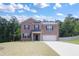 Charming two-story brick home with a well-manicured lawn and an attached two-car garage at 5417 Flat Rock Pt, Stonecrest, GA 30038