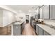 Bright kitchen boasts stainless steel appliances, granite counters, gray cabinets and a breakfast bar at 5417 Flat Rock Pt, Stonecrest, GA 30038