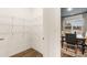 Walk-in pantry with wire shelves and view into the dining area of the home at 5417 Flat Rock Pt, Stonecrest, GA 30038