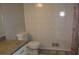 Bathroom featuring a toilet, sink, and tiled shower at 661 White Bird Way, Fairburn, GA 30213