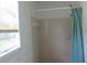 Cozy bathroom featuring a tiled shower with a blue curtain, and a window with blinds at 661 White Bird Way, Fairburn, GA 30213