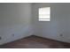 Simple bedroom featuring neutral walls, carpet, and window providing natural light at 661 White Bird Way, Fairburn, GA 30213