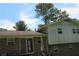 View of the back of the house with a brick facade and sliding glass door to the yard at 661 White Bird Way, Fairburn, GA 30213