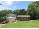 Charming two-story home with a well-maintained lawn, attached garage, and mature trees in a suburban setting at 661 White Bird Way, Fairburn, GA 30213