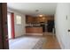 Open concept living and kitchen area with hardwood floors, wooden cabinets, and ample natural light at 661 White Bird Way, Fairburn, GA 30213