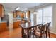 Bright dining area with wood table set next to a kitchen with wood cabinets at 251 Vinings Retreat Sw Vw, Mableton, GA 30126
