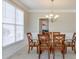 Sunlit dining room with chandelier, glass table, and seating for six at 251 Vinings Retreat Sw Vw, Mableton, GA 30126