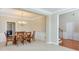 Open-concept dining room featuring a glass top table and view to the stairs and laundry at 251 Vinings Retreat Sw Vw, Mableton, GA 30126