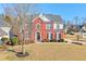 Charming red brick two-story home boasts a well-manicured lawn and mature landscaping at 251 Vinings Retreat Sw Vw, Mableton, GA 30126