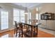 Bright living room with wood table set next to a kitchen with wood cabinets at 251 Vinings Retreat Sw Vw, Mableton, GA 30126
