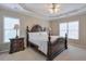 Main bedroom showcasing a large, decorative headboard, tray ceiling, and bright windows at 251 Vinings Retreat Sw Vw, Mableton, GA 30126