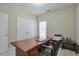 A spacious home office with a large wooden desk, chair, and a printer at 251 Vinings Retreat Sw Vw, Mableton, GA 30126