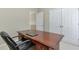 A wooden desk with a dark leather chair in a carpeted office space at 251 Vinings Retreat Sw Vw, Mableton, GA 30126