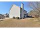 View of the home's exterior with attached garage, showcasing its clean design and spacious backyard at 251 Vinings Retreat Sw Vw, Mableton, GA 30126