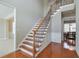 Elegant staircase features hardwood steps, wrought iron spindles, and natural light at 251 Vinings Retreat Sw Vw, Mableton, GA 30126