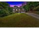 A two-story brick home sits on a hill with a long driveway at 308 Lismore Ter, Woodstock, GA 30189
