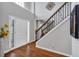 A grand entry welcomes you with gleaming hardwood floors, a staircase, and a bright, airy atmosphere at 308 Lismore Ter, Woodstock, GA 30189