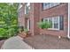 A beautiful brick home showcases mature landscaping, a well-maintained yard, and a welcoming front porch at 308 Lismore Ter, Woodstock, GA 30189