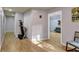 Hallway with wood floors, closet, and doorway to a living room with a couch at 308 Lismore Ter, Woodstock, GA 30189